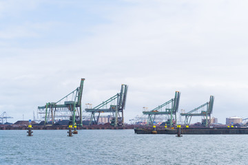Fototapeta na wymiar row of harbor cranes