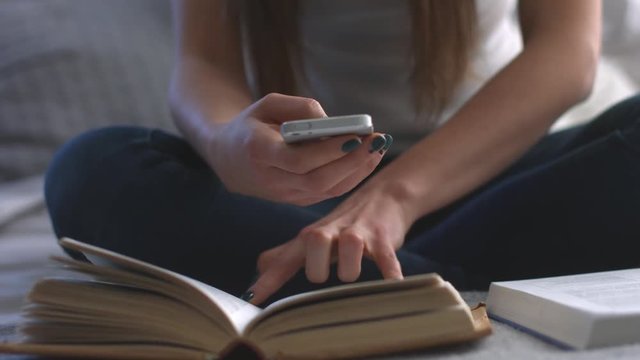 people, education, technology and exam concept - close up of students with smartphones taking picture of books page