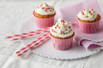 Festive cupcake with cream and heart decorations