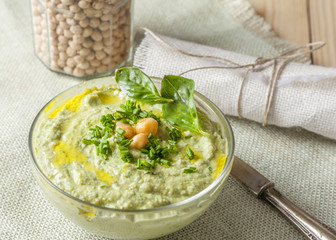 Bowl of green hummus,delicious cream of chickpeas and basil