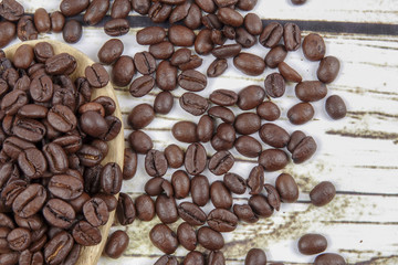 coffee beans and wooden spoon on old rusty background