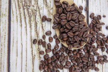 coffee beans and wooden spoon on old rusty background
