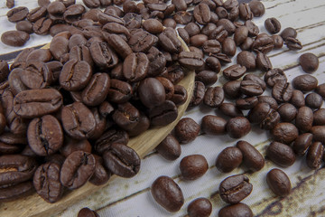 coffee beans and wooden spoon on old rusty background