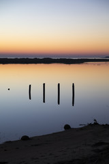 sunset with reflection in still water over nature reserve Casse de la Belle Henriette, Vendee, France