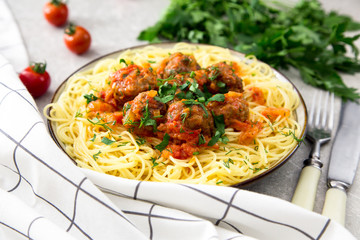 Spaghetti pasta with meatballs and parsley with tomato sauce