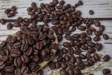 coffee beans and wooden spoon on old rusty background