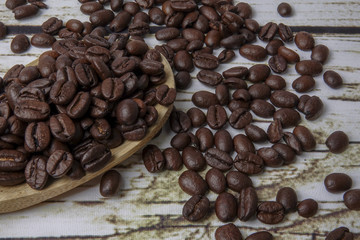 coffee beans and wooden spoon on old rusty background