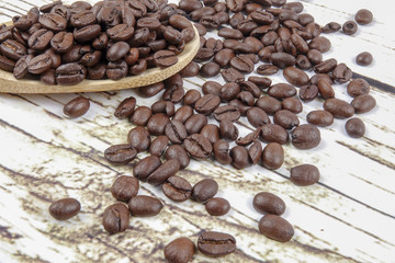 coffee beans and wooden spoon on old rusty background
