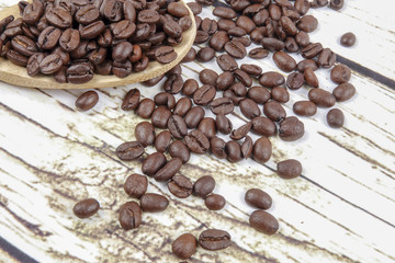 coffee beans and wooden spoon on old rusty background