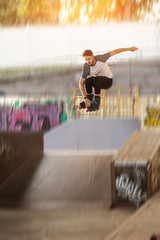 Fototapeta premium Rollerblader is jumping. Roller skater on blurred background. Defy the laws of gravity.