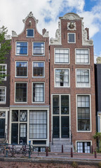 Fototapeta na wymiar Historical houses at a canal in Amsterdam