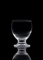 Shot of empty crystal glass on black isolated.