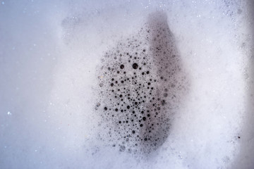 white foam and bubbles from washing.