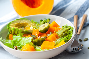 Healthy salad with pumpkin, couscous and avocado. Love for a healthy vegan food concept