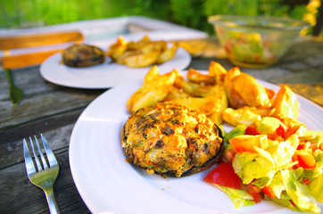 Baked portobello mushrooms with potato wedges and salad