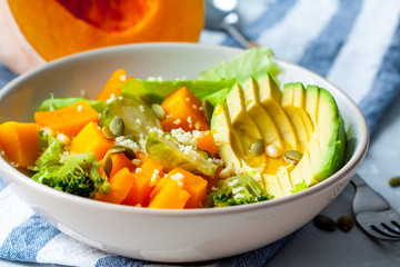 Healthy salad with pumpkin, couscous and avocado. Love for a healthy vegan food concept