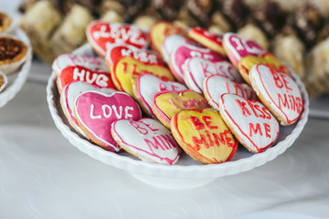 Delicious cupcakes and cookies with text at wedding reception cl