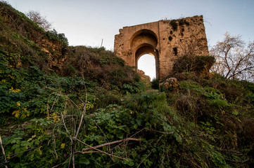 Fototapeta na wymiar Arabesque arch ruin on the top of hill