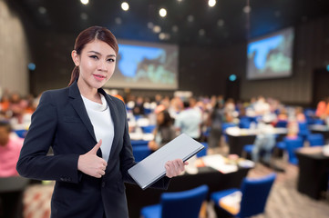Beautiful asian working woman on the Abstract blurred photo of conference hall or seminar room with...