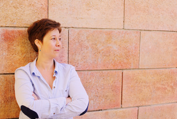 Portrait of smiling 45 years old woman outdoors