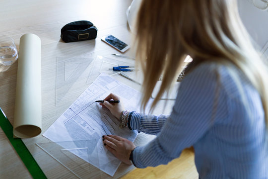 Young architect working at home drawing plans