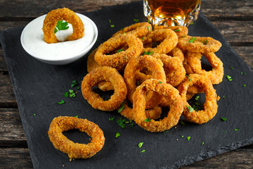 Fried Breaded Onion Rings with sauce and beer