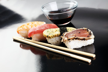 close up of sashimi sushi set with chopsticks and soy - sushi roll with salmon and sushi roll with smoked eel, selective focus.
