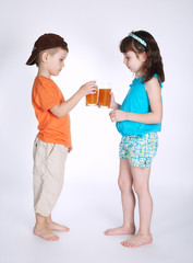 little boy and girl drinking juice