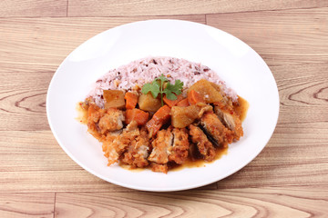 Brown rice with chicken topped Japanese yellow curry.
