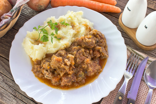 Hungarian goulash with mashed potatoes in plate on table