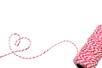 Heart made from baker's twine rope red and white on white backgr
