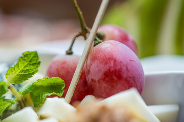 cheese plate with red grapes
