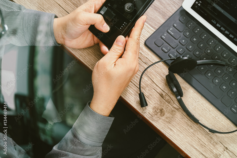 Poster top view of man hand using voip headset with digital tablet comp