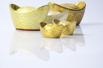 Chinese new year festival decorations,   gold ingots isolated on white. Chinese characters means luck,wealth and prosperity.
