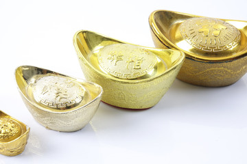 Chinese new year festival decorations,   gold ingots isolated on white. Chinese characters means...