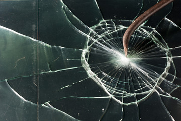 Broken glass texture. rusty crowbar