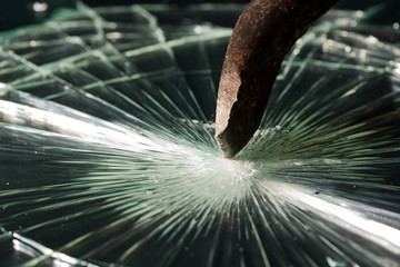 Broken glass texture. rusty crowbar
