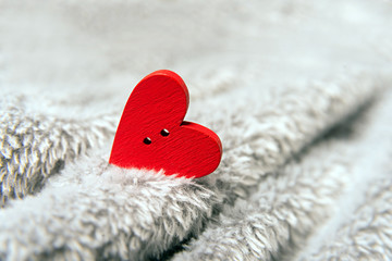 Valentines day red heart on bedspread.