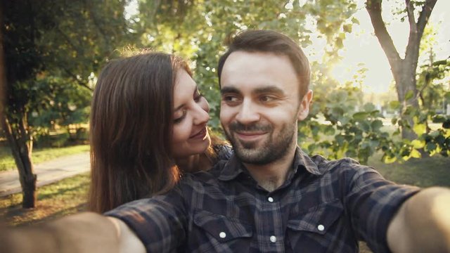 young couple is take selfie in park