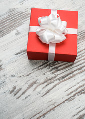 Valentines day red gift box on wooden board
