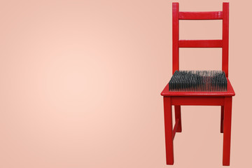 Fototapeta na wymiar red chair with spikes on the seat