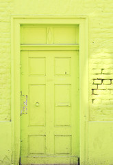 green painted door and wall of an abandoned house,grungy,