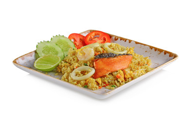 Fried rice with squid, salmon, shrimp in ceramic plate isolated