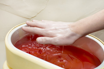 Epilation sugar processes woman passes in a beauty salon