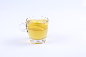 Hot lemon tea in the glass on white background.
