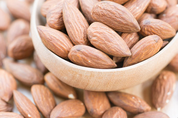 Almonds in wooden spoon