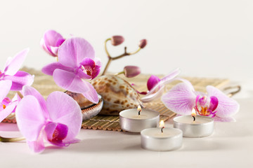 Obraz na płótnie Canvas Spa still life with aromatic candles, orchid flower sea shells
