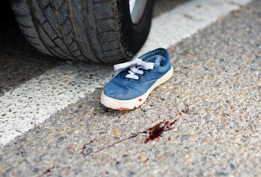 shoes in the blood under the car wheels