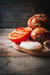 Chicken meat with vegetables on a wooden background