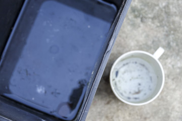 Stagnan water in rubbish container and plastic cup potentially for musquitoes breeding ground....